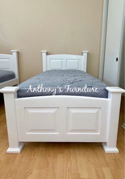 White twin bed and mattress