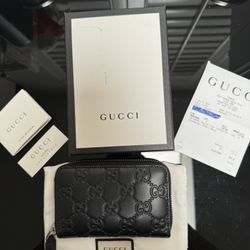 Gucci Leather Monogram Wallet.