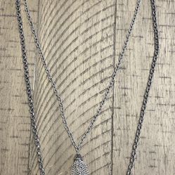  Two layered silver toned necklace with tassel charm