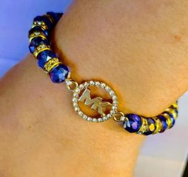 Gorgeous repurposed gold-plated MK & CZ stones, circled charm, and unique purplish blue crystal beaded bracelet