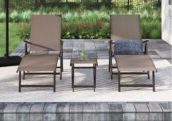 Two chaise outdoor lounge chairs with small table