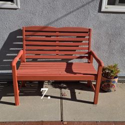 Orange outdoor wooden bench