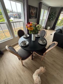 Dining room table with chairs and decorative plates