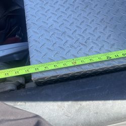 The item pictured is a diamond plate aluminum truck tool box designed for secure storage in a pickup truck bed.