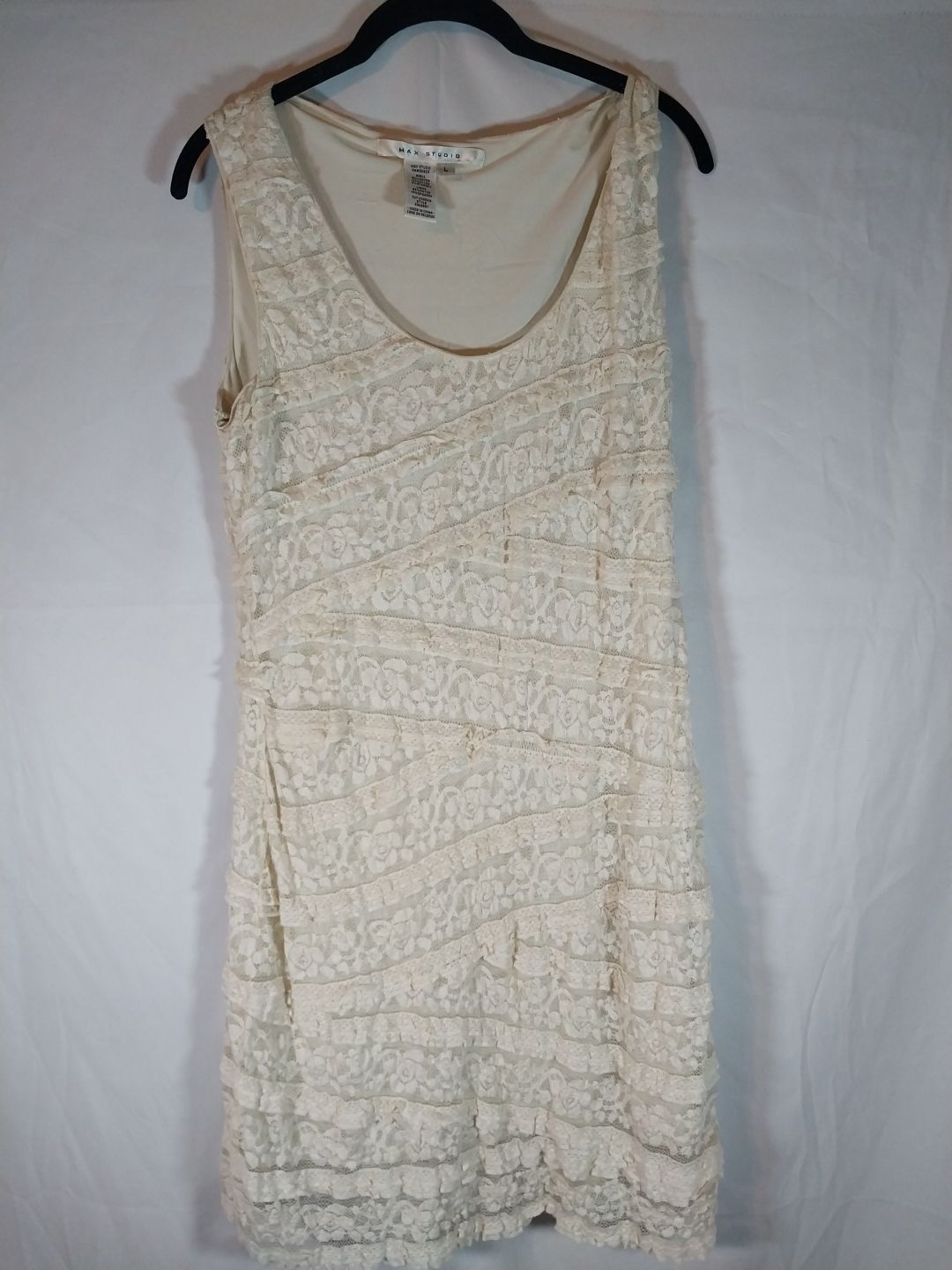cream-colored floral lace design with ruffled tiers