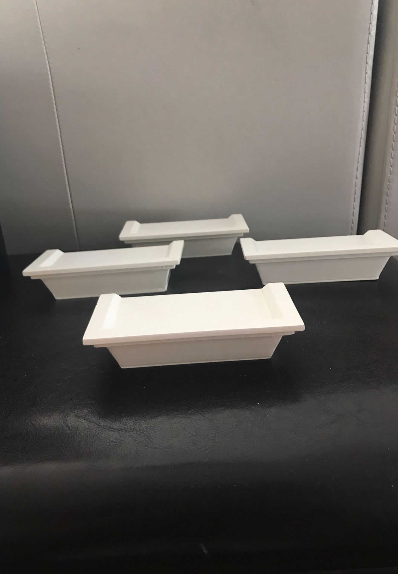 Set of four white hanging bookshelf or display piece