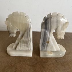 vintage carved marble stone horse head bookends, likely crafted in a Mid-Century Modern or Art Deco style.  Material: Usually carved from marble, ofte