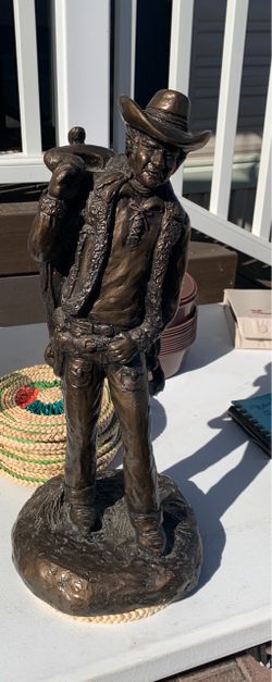 Standing cowboy with saddle