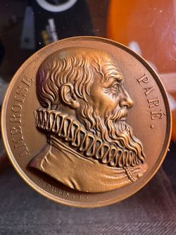 bronze commemorative medal depicting Ambroise Paré, a pioneering French surgeon known as the father of modern surgery.  