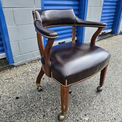 Antique style office captain's chair with dark brown leather upholstery
