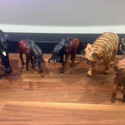 A collection of 6 vintage leather clad animals comprising of elephant, tiger, 2 bulls and 2 elks.