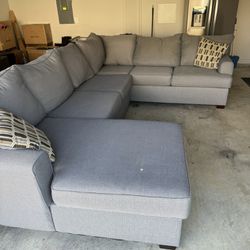 Gray Couch With Minor Imperfection