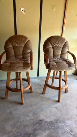 Two brown swivel chairs