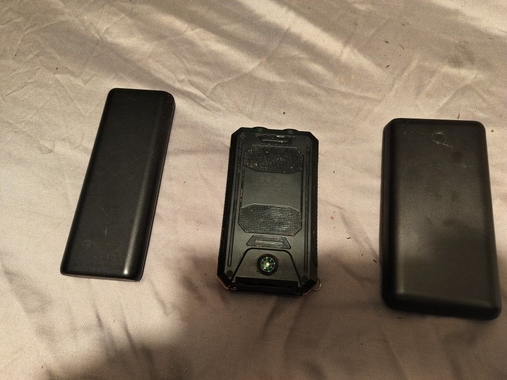 Battery Packs Anker, Onn And A Third Which Also Has A Solar Panel and A Flashlight