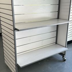 Slatwall display on wheels with 4 shelves & metal hangers. Retail storage. 
