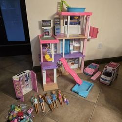 Barbie house with dolls and cars