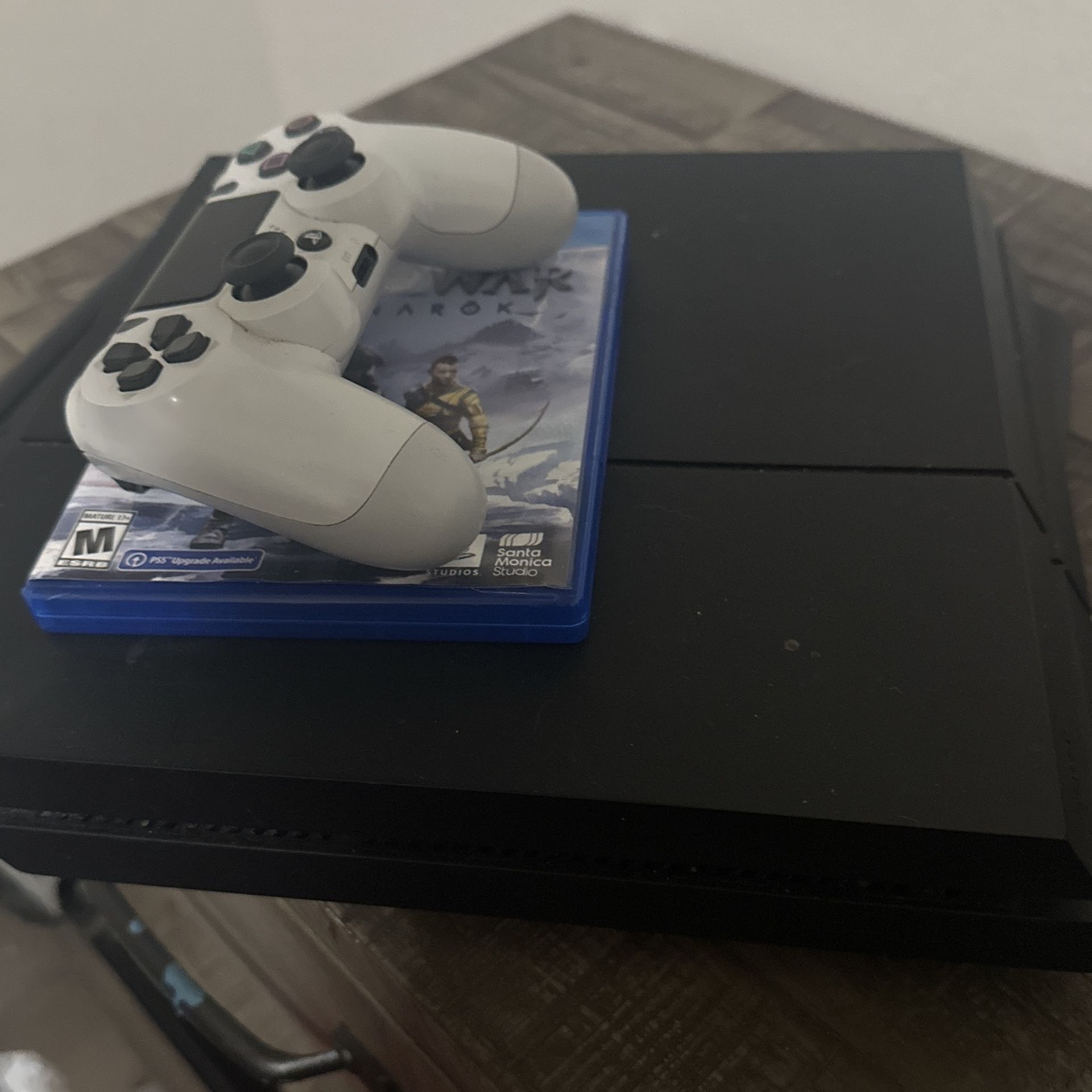 PS4 With Controller And God Of War Ragnarok
