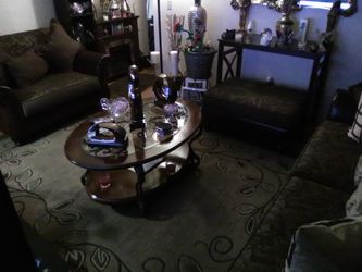 Coffee and a in table and a couch and a chair in a half set and a Ottoman