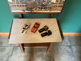 vintage 1970s or 1980s radio-controlled cars, specifically a Porsche 935 Turbo with Martini Racing livery and a Mazda RX-7.The set includes two black 