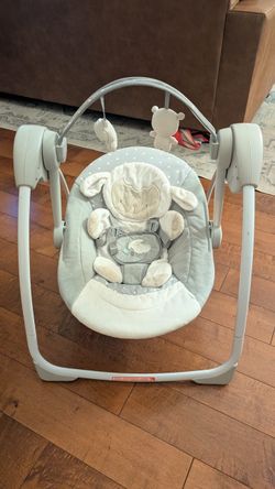 Baby swing:  Ingenuity Comfort 2 Go Compact Portable 6-Speed Cushioned Baby Swing with Music, Folds Easy, 0-9 Months 6-20 lbs (Cuddle Lamb)
