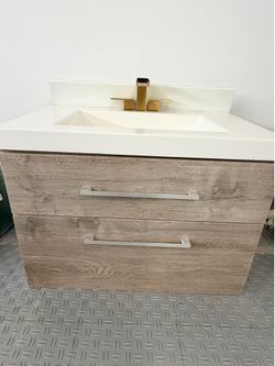 Modern Floating Vanity sink with gold hardware and backsplash