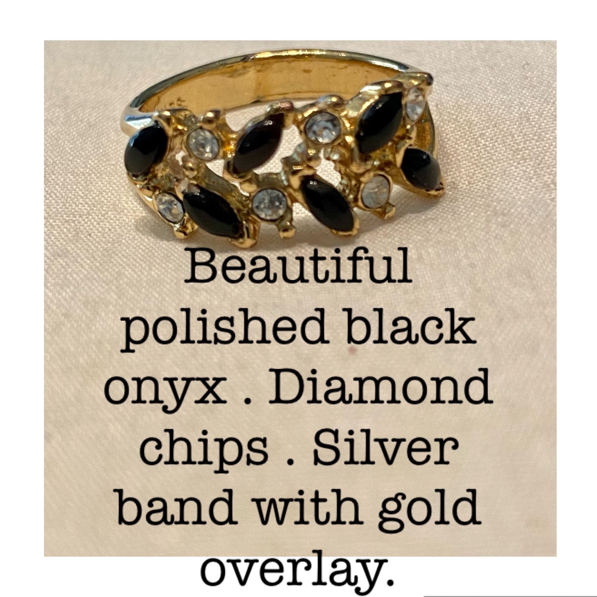 Polished black onyx with diamond chips and a silver band with a gold overlay.
