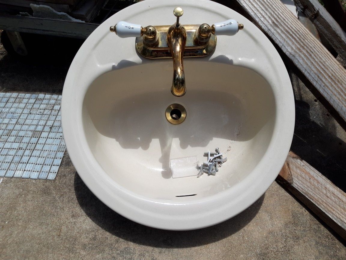 Beige Sink and Gold Faucet With Drain