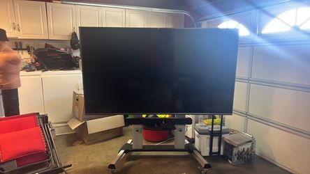 TCL 85 inch TV WITH COMMERCIAL MOBILE STAND.