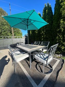 7 piece outdoor dinning table umbrella included and cushions