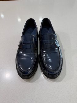 Cole Haan glossy navy penny loafers.