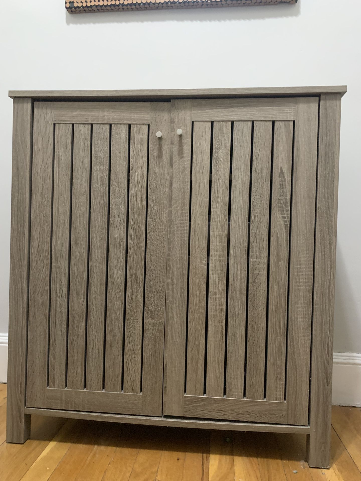 Storage cabinet with two doors slat style vented doors metal knob handle
