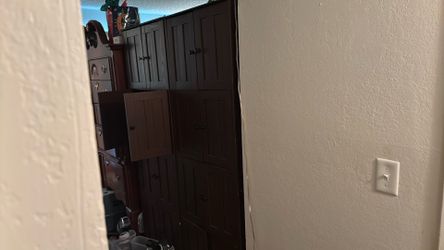2 brown tall cabinets with 4 shelves each of cabinet space