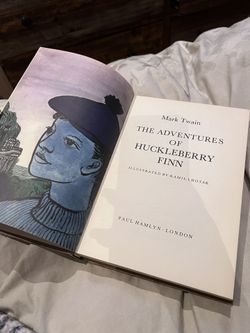 The Adventures of Huckleberry Finn by Mark Twain.