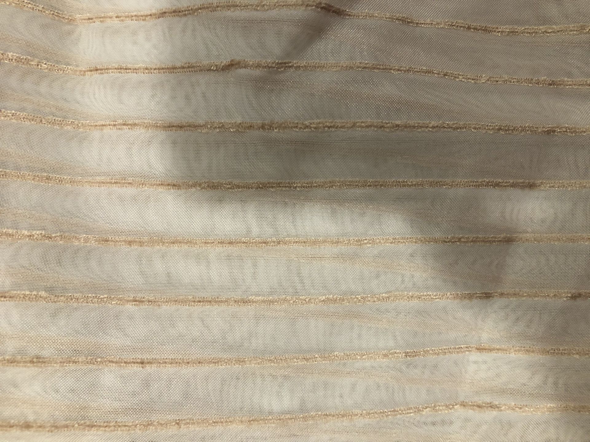 Sheer upholstery fabric with textured tan stripes.