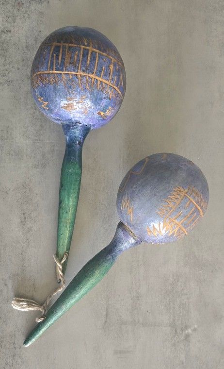 Beautifully handcrafted maracas with intricate designs. Features a blend of blue and green colors.