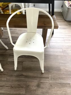 2 White “Carlisle” metal bistro chairs