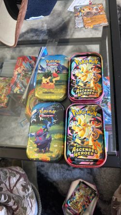 Two ascended heroes tins