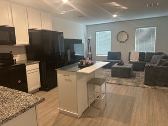 Kitchen island, stainless steel and wood. Two seats, trash and Storage.
