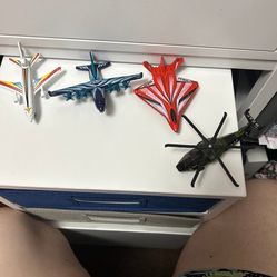 3 toy planes and a toy helicopter