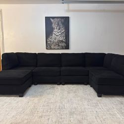 Black 5-Seater Modular Sectional Sofa with Ottoman.