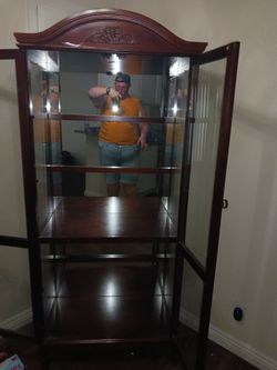 Old fashioned cabinet with mirrors but in the back wall glass doors