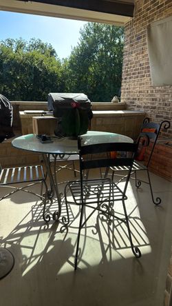 Iron table and chairs with a glass top