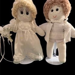 Wedding handmade rag dolls dressed in wedding attire.  The dolls are made of cloth with yarn hair, stitched facial features, and freckles.  The female