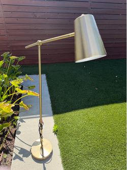 Details Highlights Black and brass spotlight floor lamp with LED bulbs Includes 4 LED bulbs Touch-activated sensor Electric plug-in power source