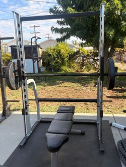 Smith machine with a flat bench and a pair of 45 pounds. Bumper plates all in good condition  pick up in sun valley cash only