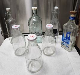 Tall Glass Bottles with lids.