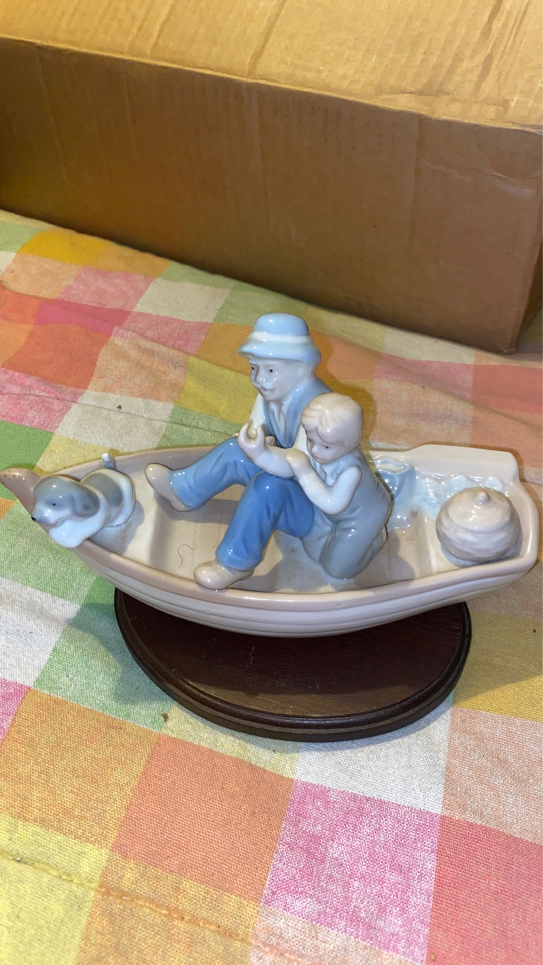 Porcelain fishing boat with man, boy and dog