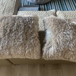 Two decorative shaggy pillows