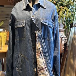 This lightweight denim jacket showcases a classic blue color and a traditional trucker style. It features a shirt-style collar and a comfortable fit, 