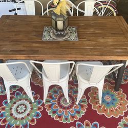 Outside farm wood table and chairs and colorful outside rug included